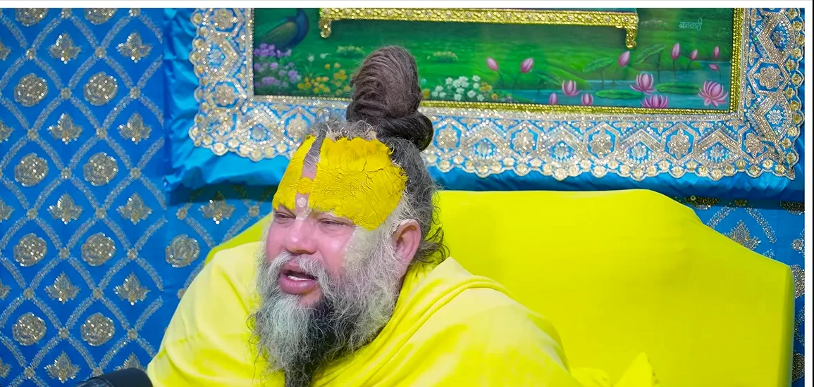Premanand Ji Maharaj a close portrait before a blue backdrop