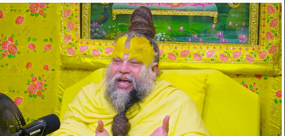 Premanand Ji Maharaj both hands raised, yellow floral backdrop