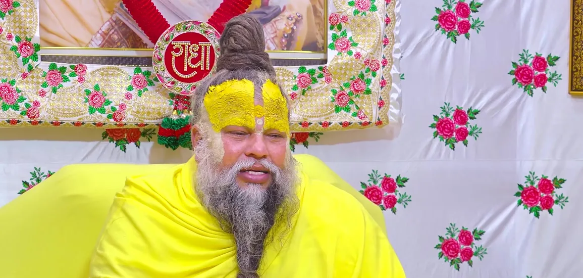 Premanand Ji Maharaj a close portrait against the floral cloth of the hall