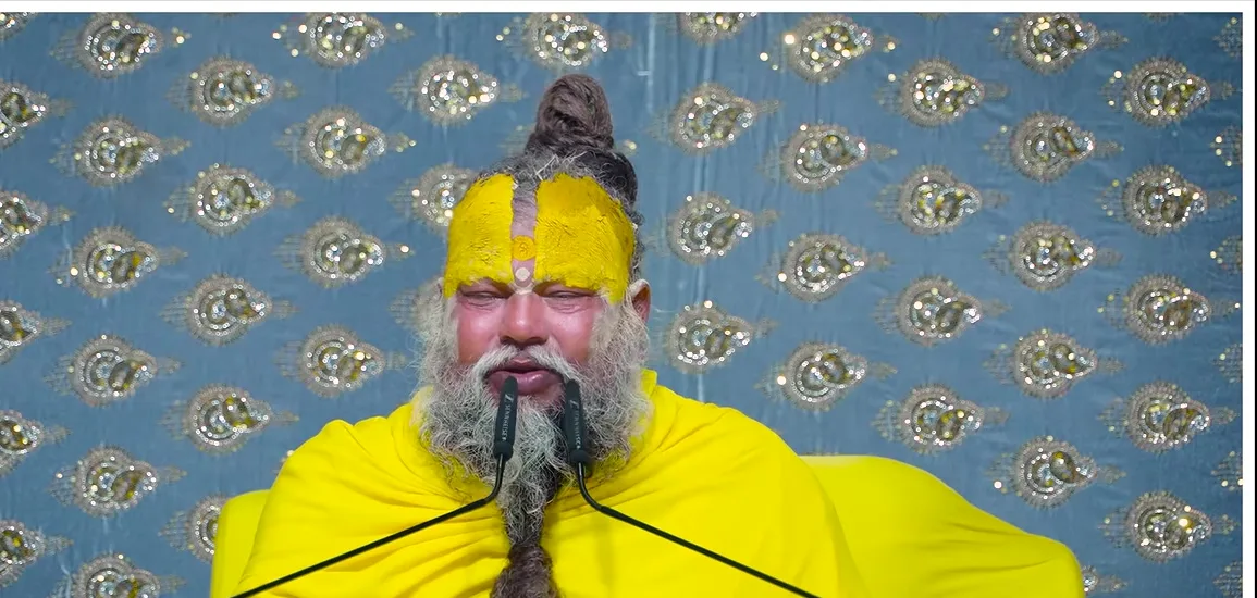Premanand Ji Maharaj a portrait before a grey damask backdrop
