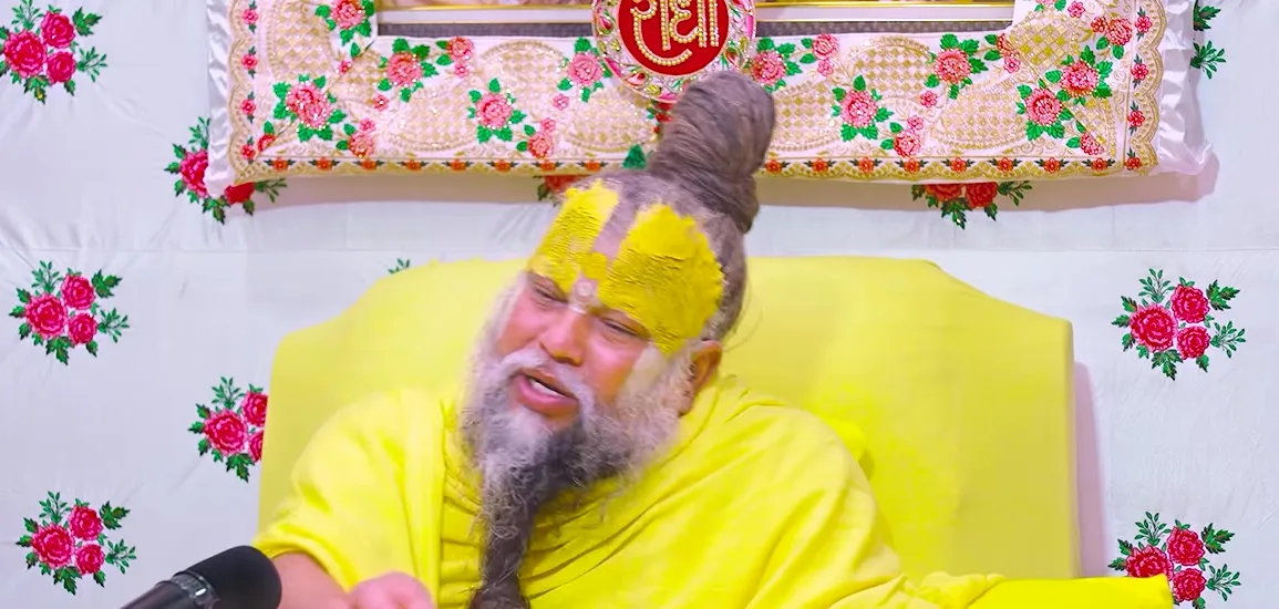 Premanand Ji Maharaj hand at the chin, listening to a question