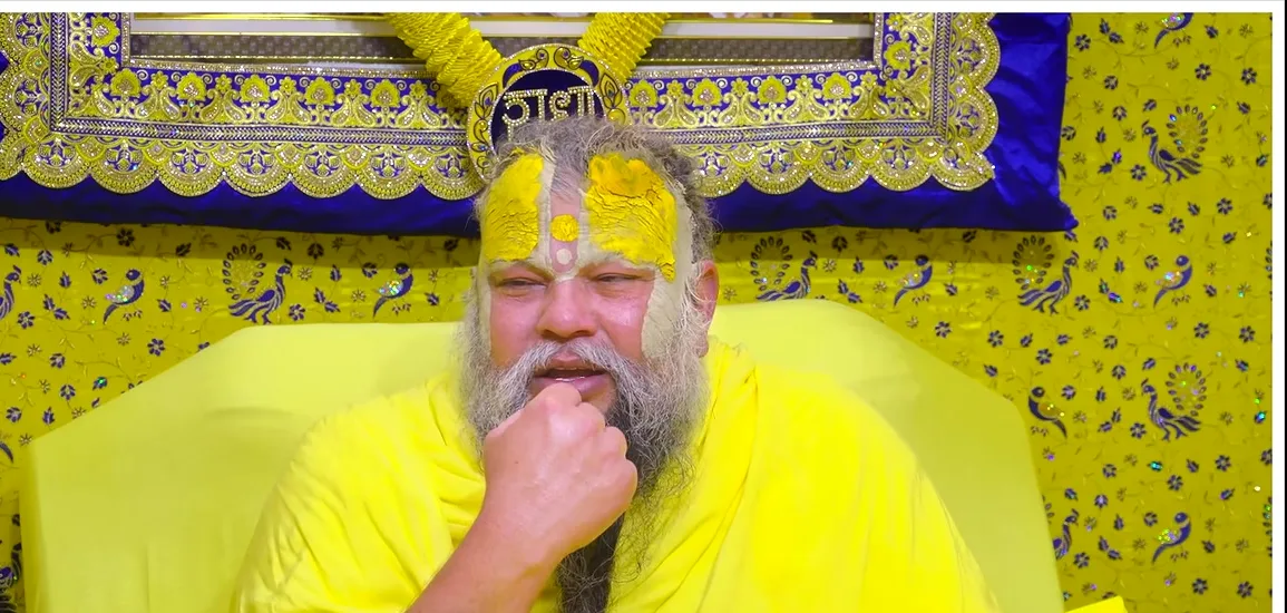 Premanand Ji Maharaj hand at the beard, listening during satsang