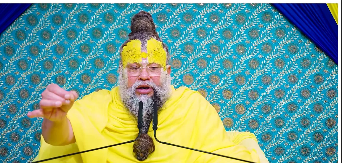 Premanand Ji Maharaj pointing while speaking, teal backdrop